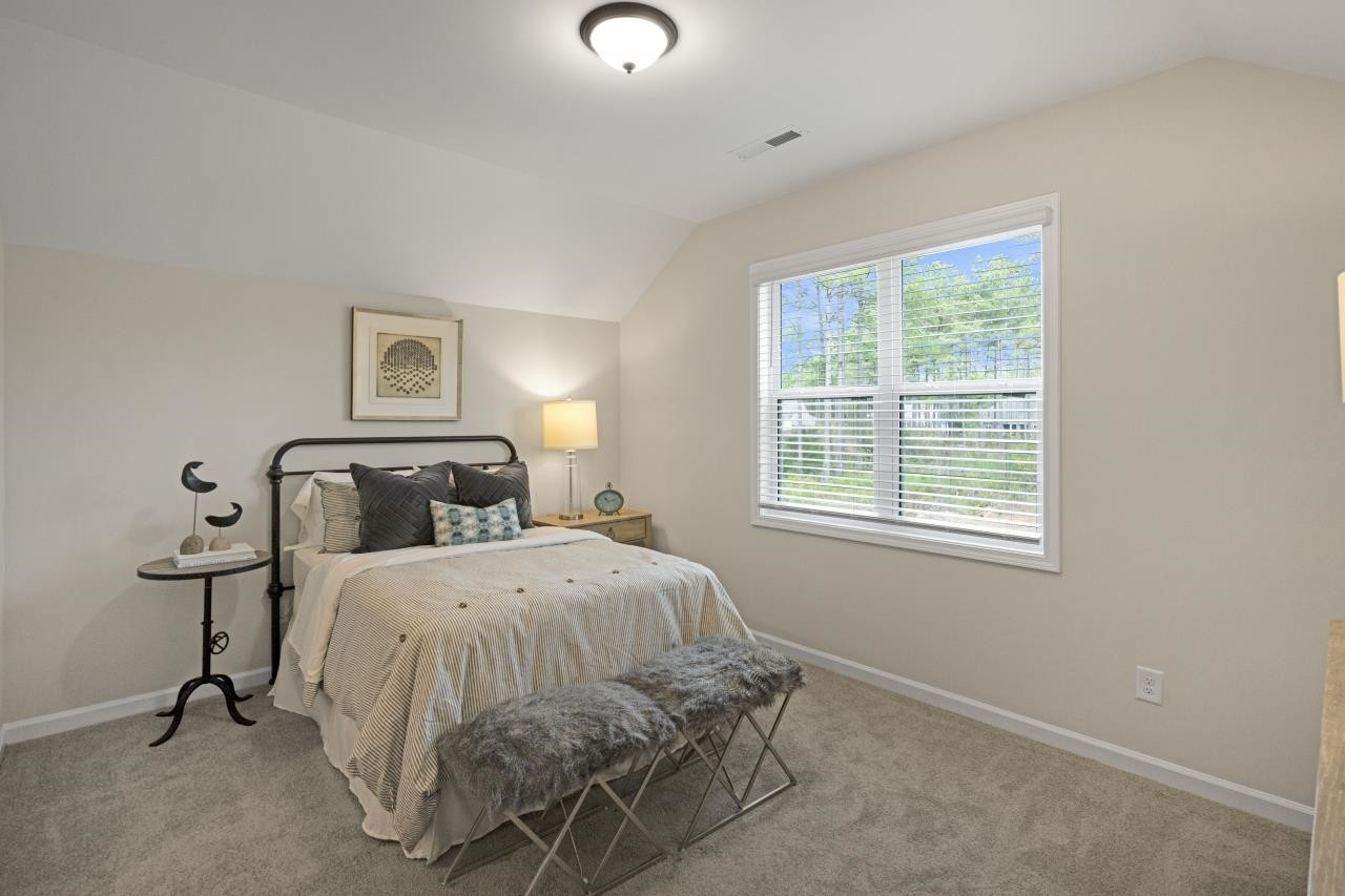 350 Madden Rose Loop Garner, NC 27529 - Photo 22 of 27 a bedroom with bed and a window