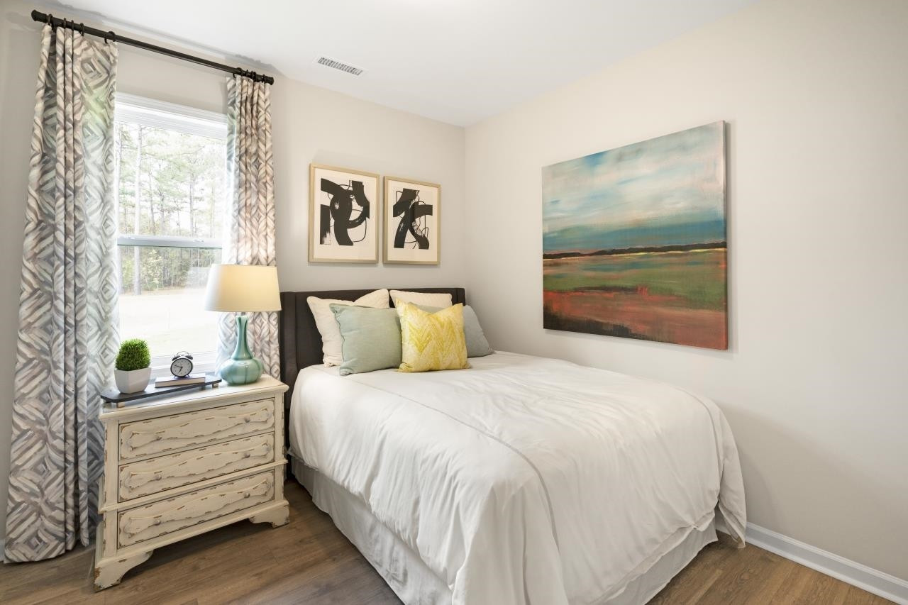 350 Madden Rose Loop Garner, NC 27529 - Photo 23 of 27 a bedroom with a bed and a painting on the wall