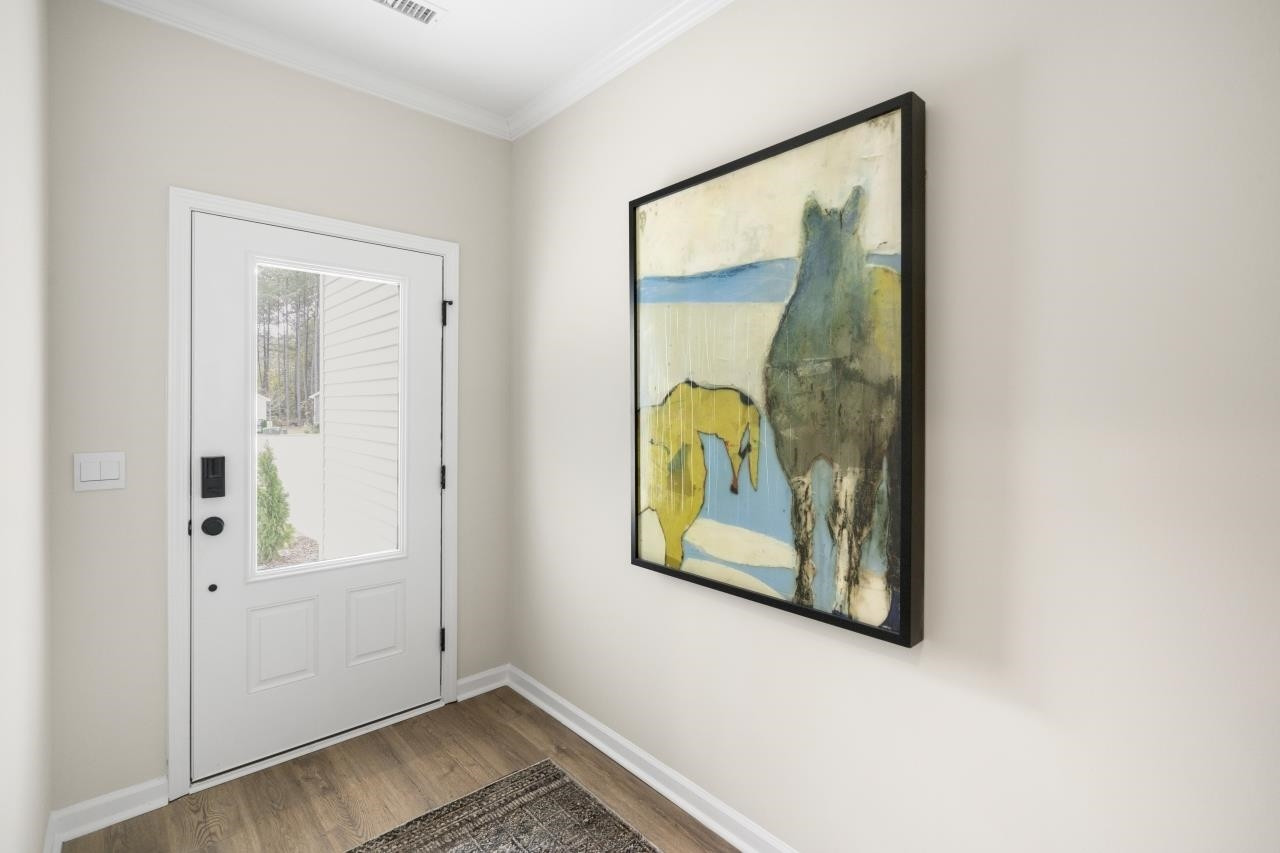 350 Madden Rose Loop Garner, NC 27529 - Photo 7 of 27 a view of a bathroom with a painting on the wall