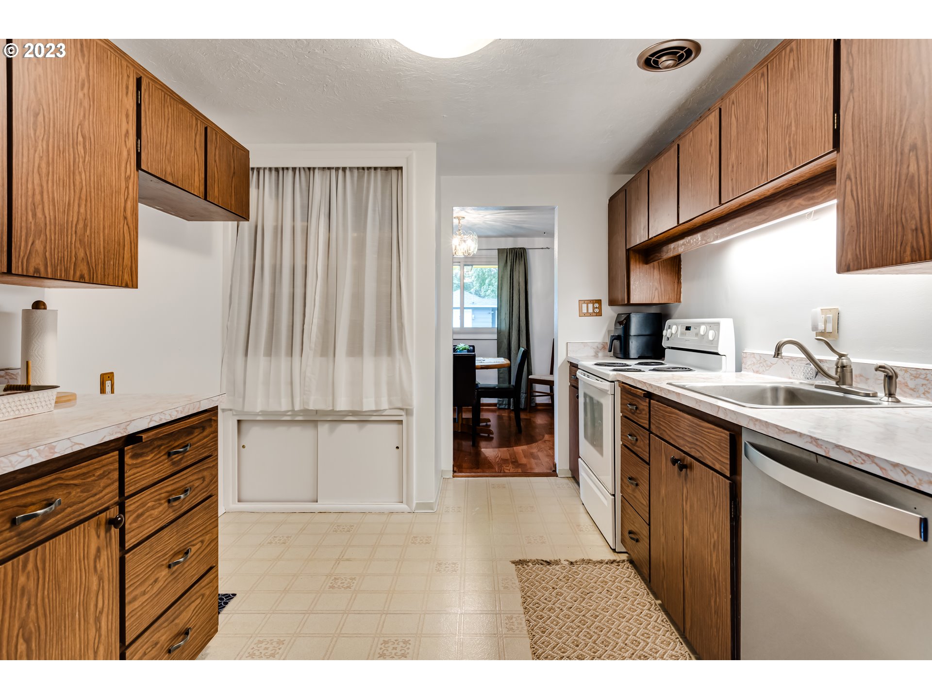 959 Laurelhurst Drive Eugene, OR 97402 - Photo 11 of 30 a kitchen with granite countertop a sink cabinets and stainless steel appliances