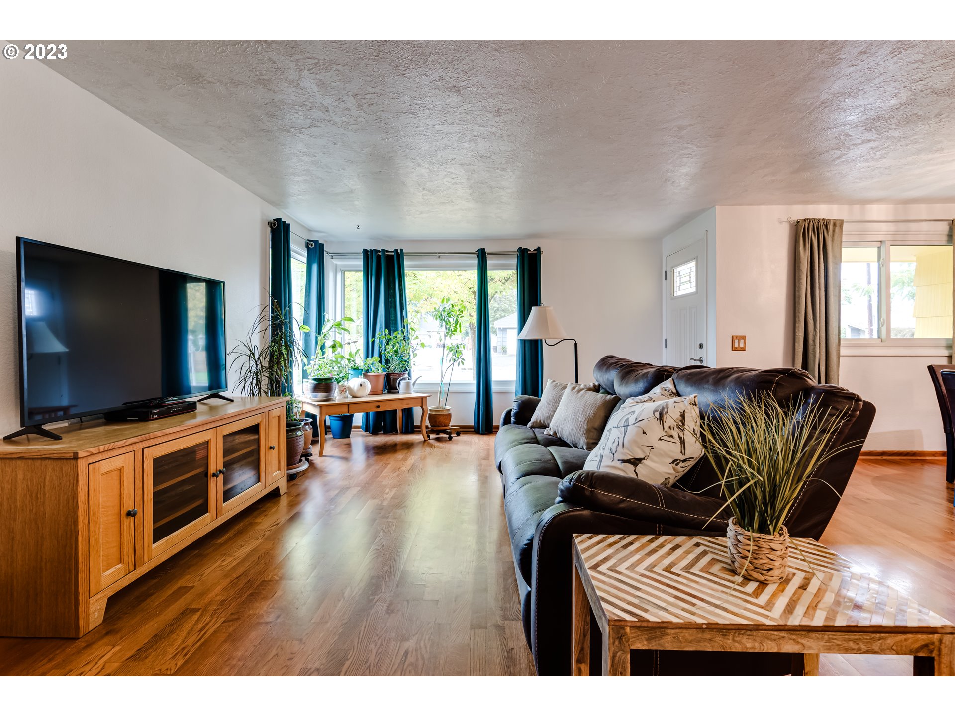 959 Laurelhurst Drive Eugene, OR 97402 - Photo 5 of 30 a living room with furniture and a flat screen tv