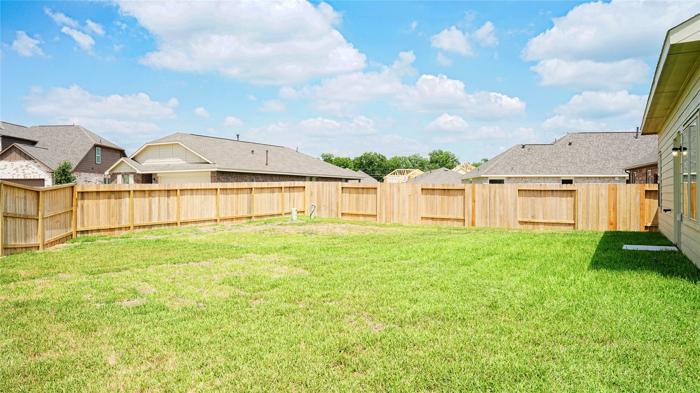 3358 Avary River Lane Rosenberg, TX 77471 - Photo 22 of 22 a view of a big yard with large tree and wooden fence