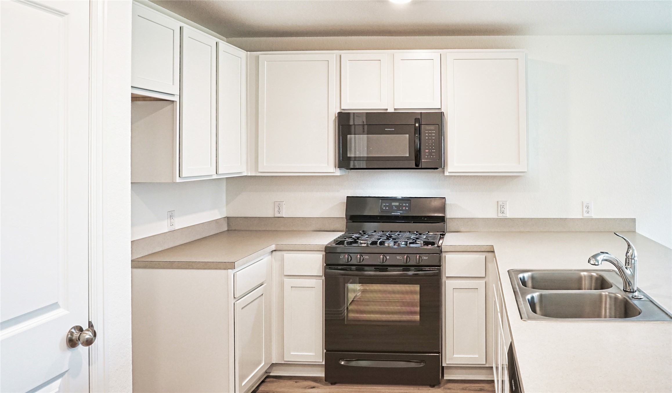 3358 Avary River Lane Rosenberg, TX 77471 - Photo 4 of 22 a kitchen with cabinets stainless steel appliances and a sink