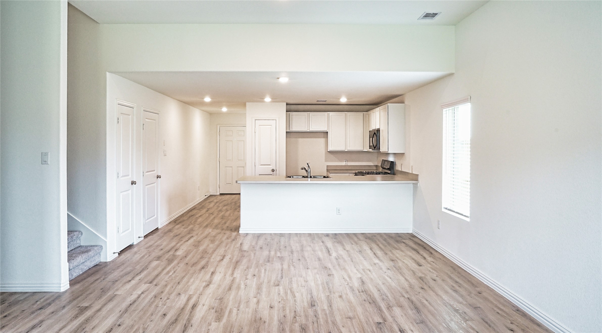 3358 Avary River Lane Rosenberg, TX 77471 - Photo 7 of 22 a view of kitchen with granite countertop cabinets and wooden floor
