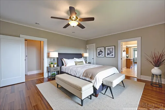 a bedroom with a large bed and a chandelier