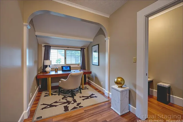 a living room with furniture and wooden floor