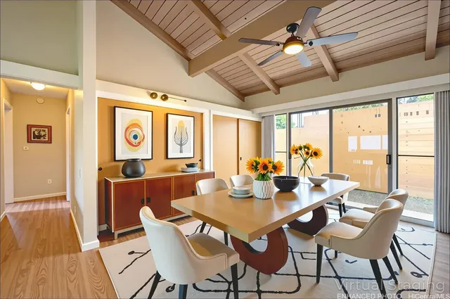 a view of a dining room with furniture large windows and wooden floor