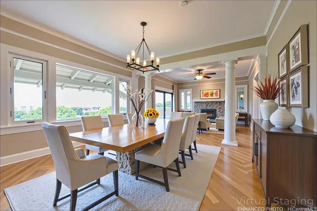 a dining room with furniture a chandelier and wooden floor