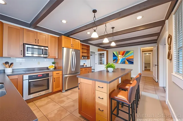 a kitchen with stainless steel appliances granite countertop a stove a sink dishwasher and a refrigerator