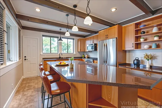 a kitchen with stainless steel appliances granite countertop a refrigerator a sink and a stove