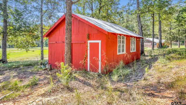 a view of a wooden deck with chairs and a yard