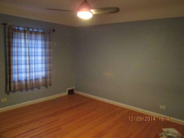 315 Selborne Road Riverside, IL 60546 - Photo 7 of 22 a view of an empty room with wooden floor and a window