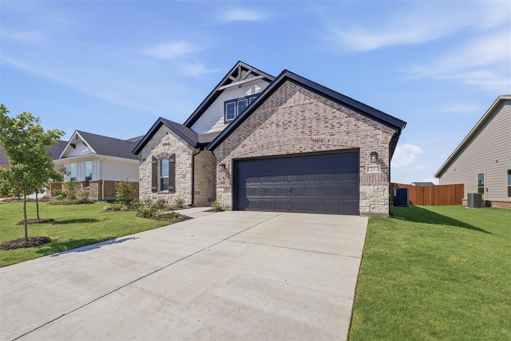 1213 Colca Drive Springtown, TX 76082 - Photo 4 of 23 Stone and brick facade with a two-car garage