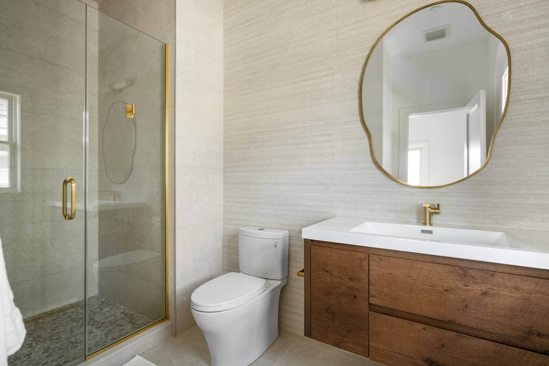 686 Dune Road Westhampton Beach, NY 11978 - Photo 17 of 37 a bathroom with a sink toilet and shower