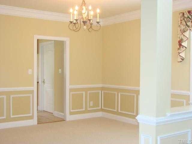 9012 Winged Thistle Court Raleigh, NC 27617 - Photo 4 of 12 The dining room is open to the foyer and has an accent column,picture frame molding,and chair rail.