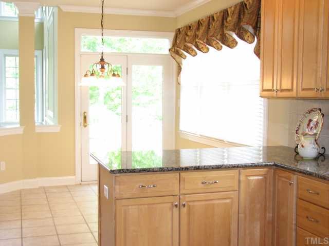 9012 Winged Thistle Court Raleigh, NC 27617 - Photo 6 of 12 The breakfast room enjoys ceramic tile floors and access to the deck. The maple cabinets and distinctive granite counter tops enhance the kitchen.