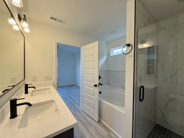 a bathroom with a bathtub and shower