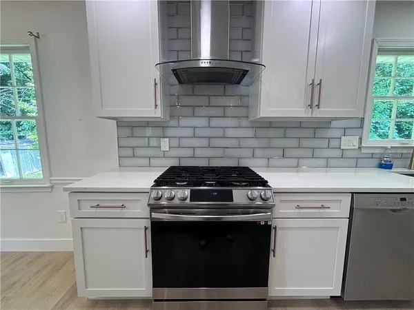 a stove top oven sitting inside of a kitchen
