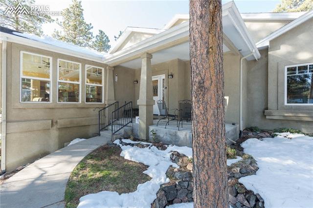17873 Sawmill Road Colorado Springs, CO 80908 - Photo 3 of 36 Entrance to this beautiful home with inviting front porch with lots of beautiful stone retaining walls