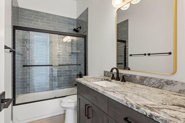 2862 South Mountain Rnch Road Cedar City, UT 84720 - Photo 40 of 64 Bathroom featuring a vanity with a white rectangular sink and dark bronze faucet, set into a stone countertop