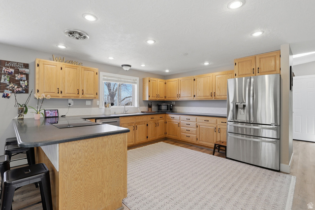 114 North Clark Lane Elk Ridge, UT 84651 - Photo 5 of 26 Kitchen featuring light wood cabinetry, dark countertops, and recessed lighting