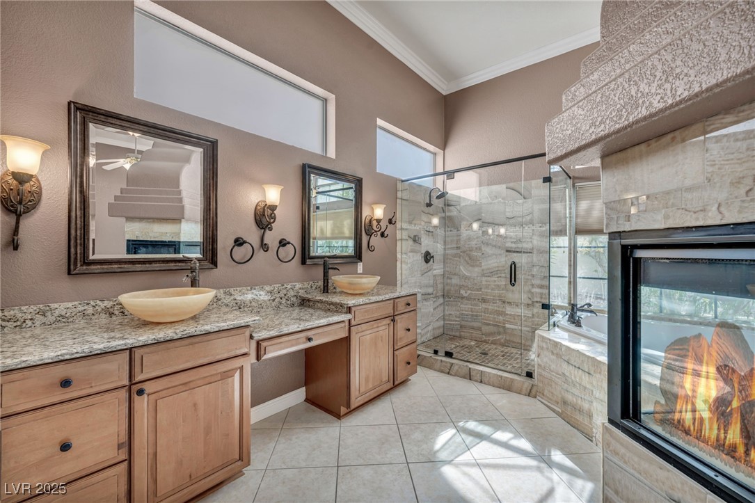 2107 Eaglepath Circle Henderson, NV 89074 - Photo 37 of 84 Bathroom with double vanity, plenty of natural light, a stall shower, ornamental molding, and light tile patterned flooring