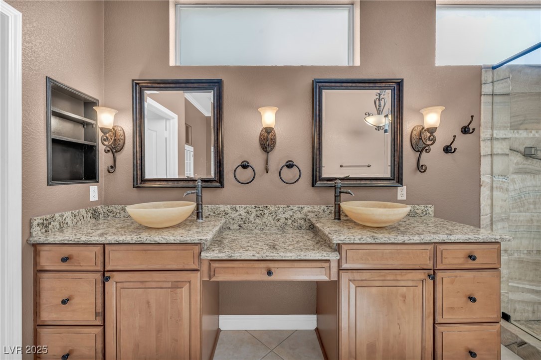 2107 Eaglepath Circle Henderson, NV 89074 - Photo 38 of 84 Bathroom featuring double vanity, a shower stall, a textured wall, and tile patterned floors