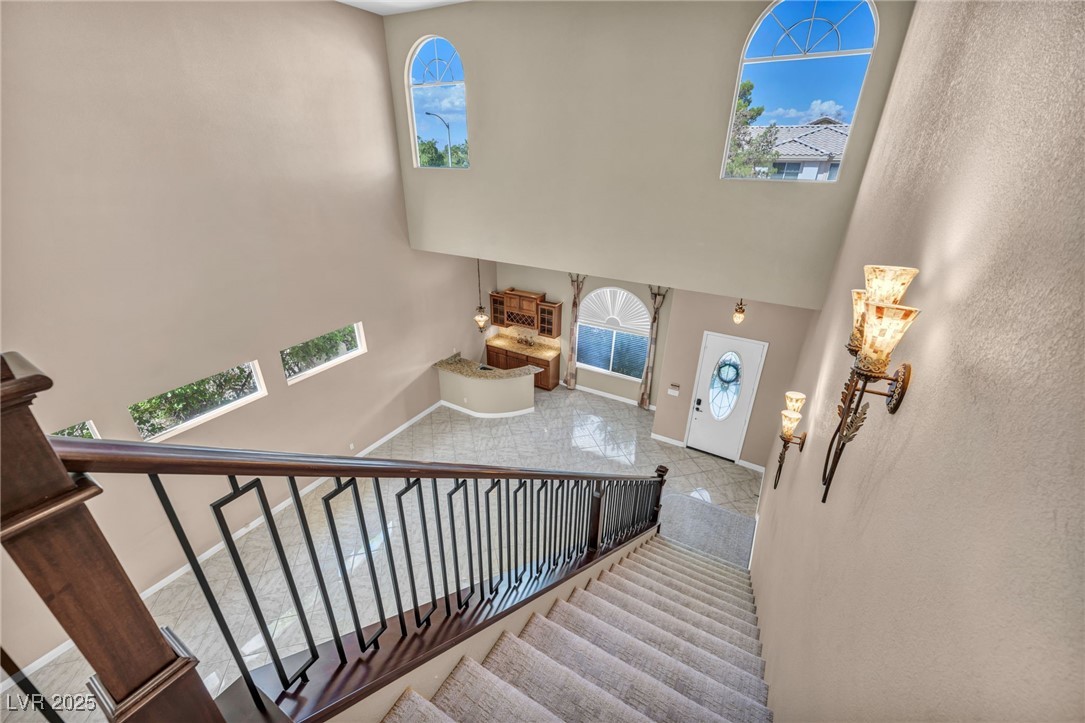 2107 Eaglepath Circle Henderson, NV 89074 - Photo 39 of 84 Staircase featuring a high ceiling and plenty of natural light