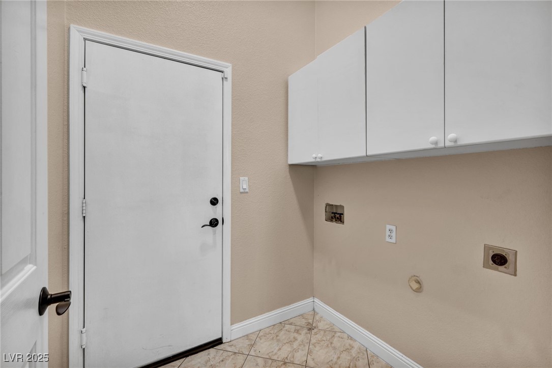 2107 Eaglepath Circle Henderson, NV 89074 - Photo 51 of 84 Washroom featuring cabinet space, washer hookup, gas dryer hookup, hookup for an electric dryer, and light tile patterned floors