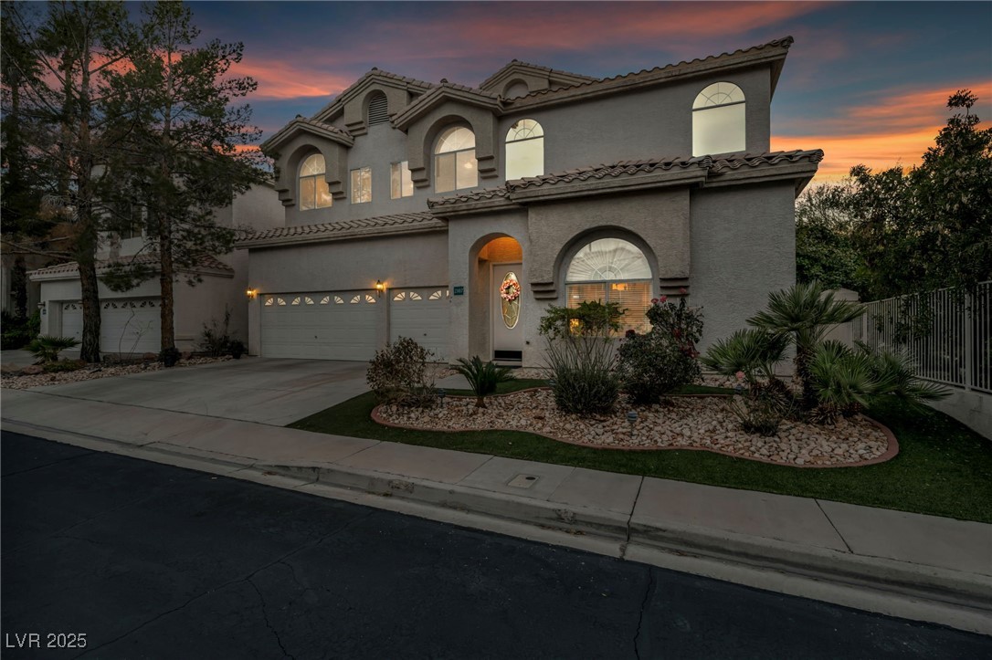 2107 Eaglepath Circle Henderson, NV 89074 - Photo 53 of 84 Mediterranean / spanish-style house with stucco siding, driveway, a garage, and a tile roof