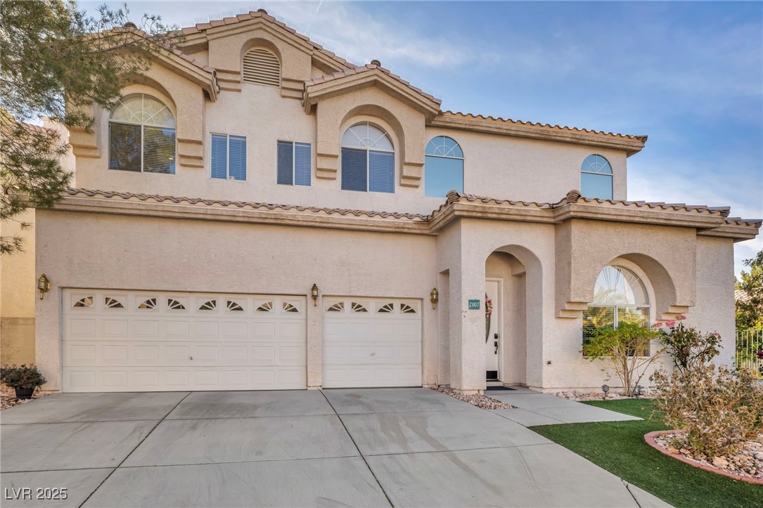 2107 Eaglepath Circle Henderson, NV 89074 - Photo 56 of 84 Mediterranean / spanish-style house featuring stucco siding, concrete driveway, a garage, and a tiled roof