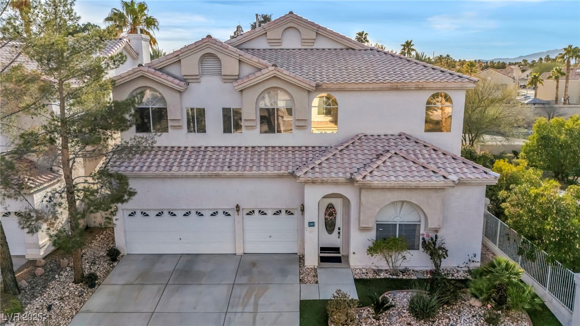 2107 Eaglepath Circle Henderson, NV 89074 - Photo 64 of 84 Mediterranean / spanish-style home with concrete driveway, stucco siding, a tiled roof, and a chimney