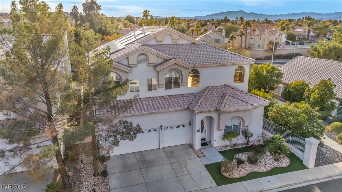 2107 Eaglepath Circle Henderson, NV 89074 - Photo 76 of 84 Mediterranean / spanish-style house featuring stucco siding, a tiled roof, driveway, and a residential view