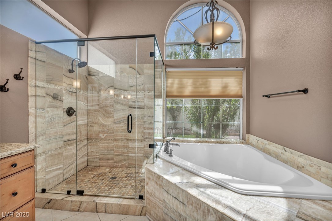 2107 Eaglepath Circle Henderson, NV 89074 - Photo 9 of 84 Full bath with a shower stall, a garden tub, healthy amount of natural light, and a textured wall