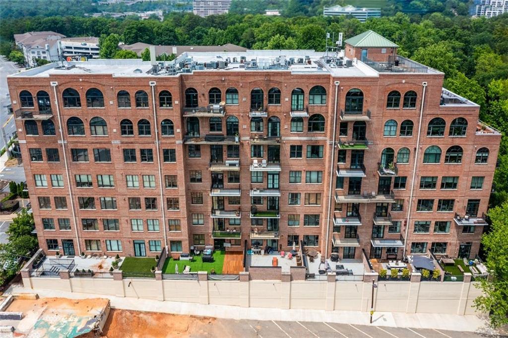 3235 Roswell Road Northeast, Unit 702 Atlanta, GA 30305 - Photo 11 of 16 a view of a building with a yard