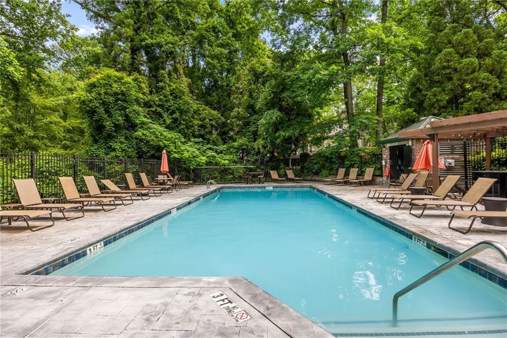 3235 Roswell Road Northeast, Unit 702 Atlanta, GA 30305 - Photo 14 of 16 a view of a swimming pool with a patio