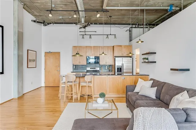 a living room with stainless steel appliances granite countertop lots of furniture