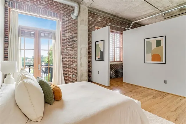 a bedroom with a bed and a painting on the wall