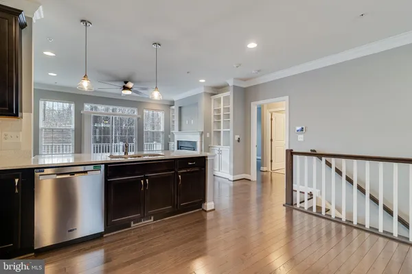 a open kitchen with stainless steel appliances granite countertop a stove and a sink with wooden floor