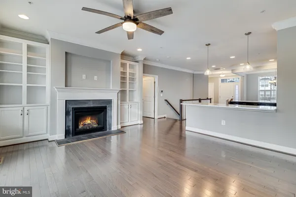 a view of an empty room and kitchen view
