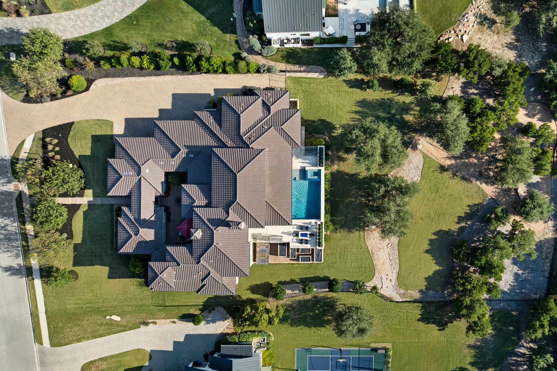an aerial view of residential houses with outdoor space and swimming pool
