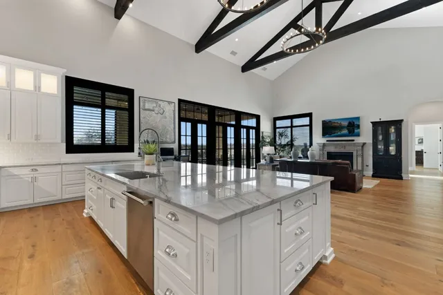 a large white kitchen with a large window