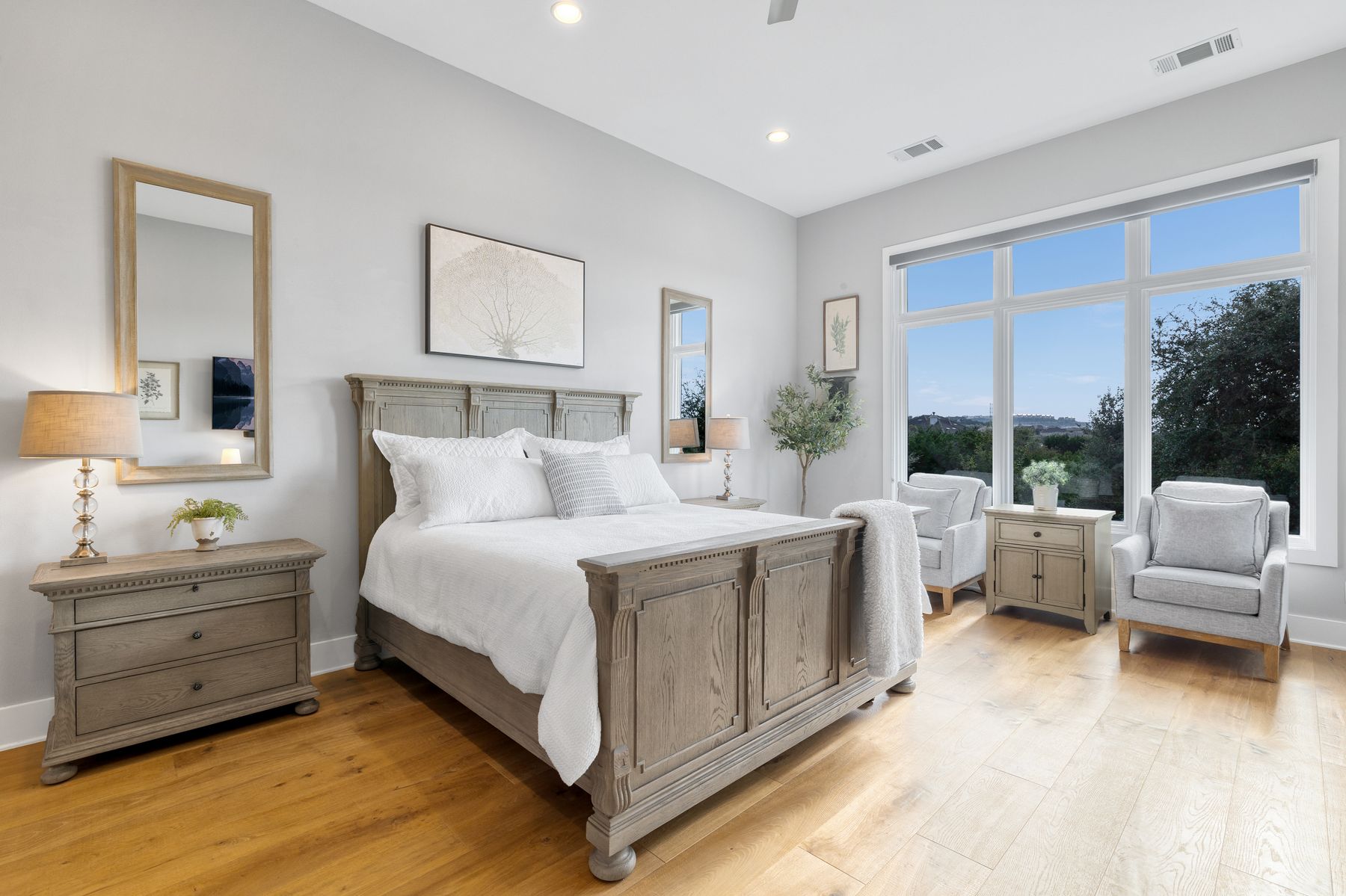 496 Primo Fiore Terrace Austin, TX 78738 - Photo 12 of 40 a spacious bedroom with a bed and a couch