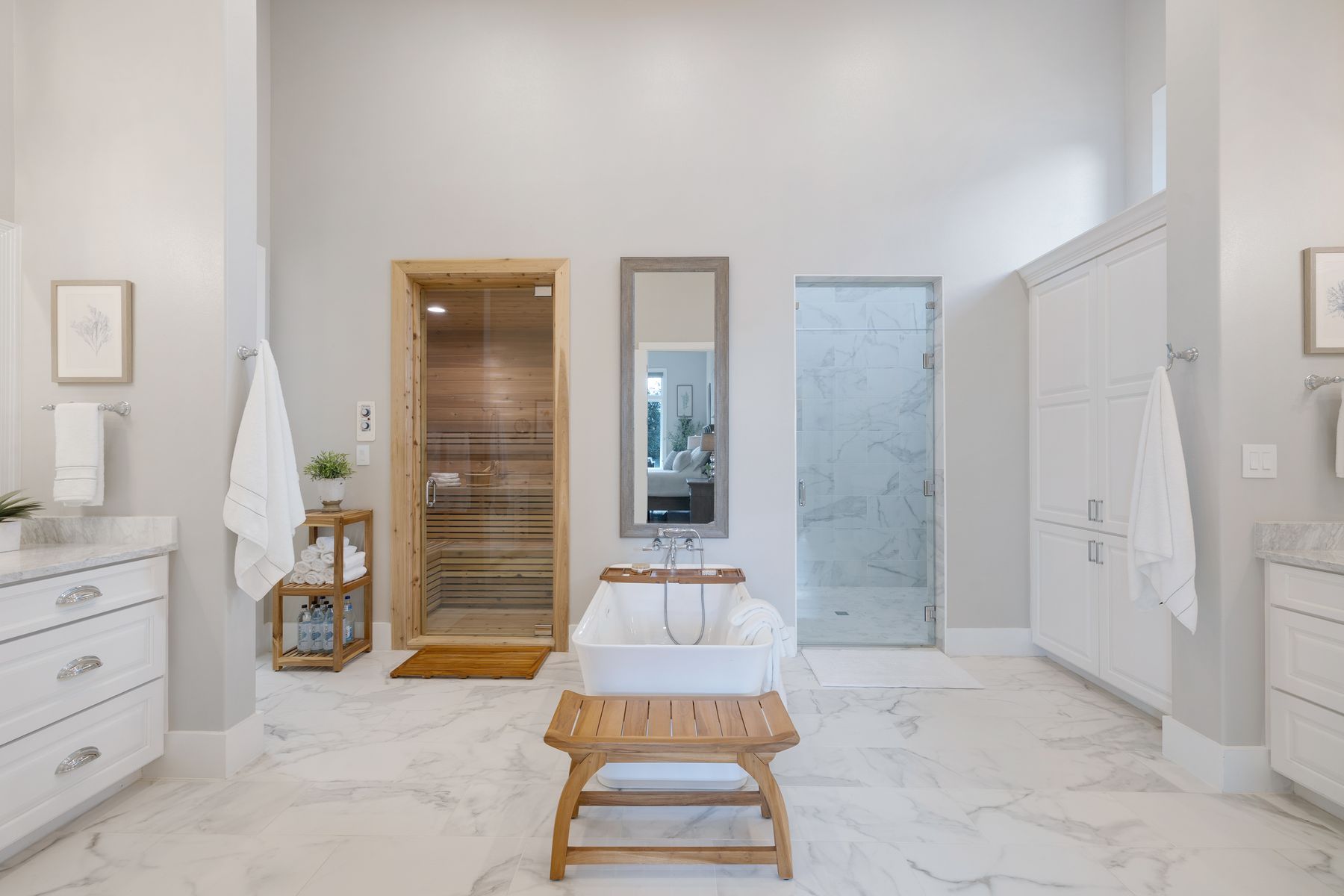 496 Primo Fiore Terrace Austin, TX 78738 - Photo 13 of 40 Bathroom featuring vanity, a high ceiling, a marble finish shower, a soaking tub, and light marble finish floors