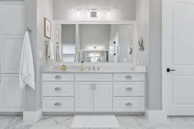 a bathroom with a sink vanity and mirror