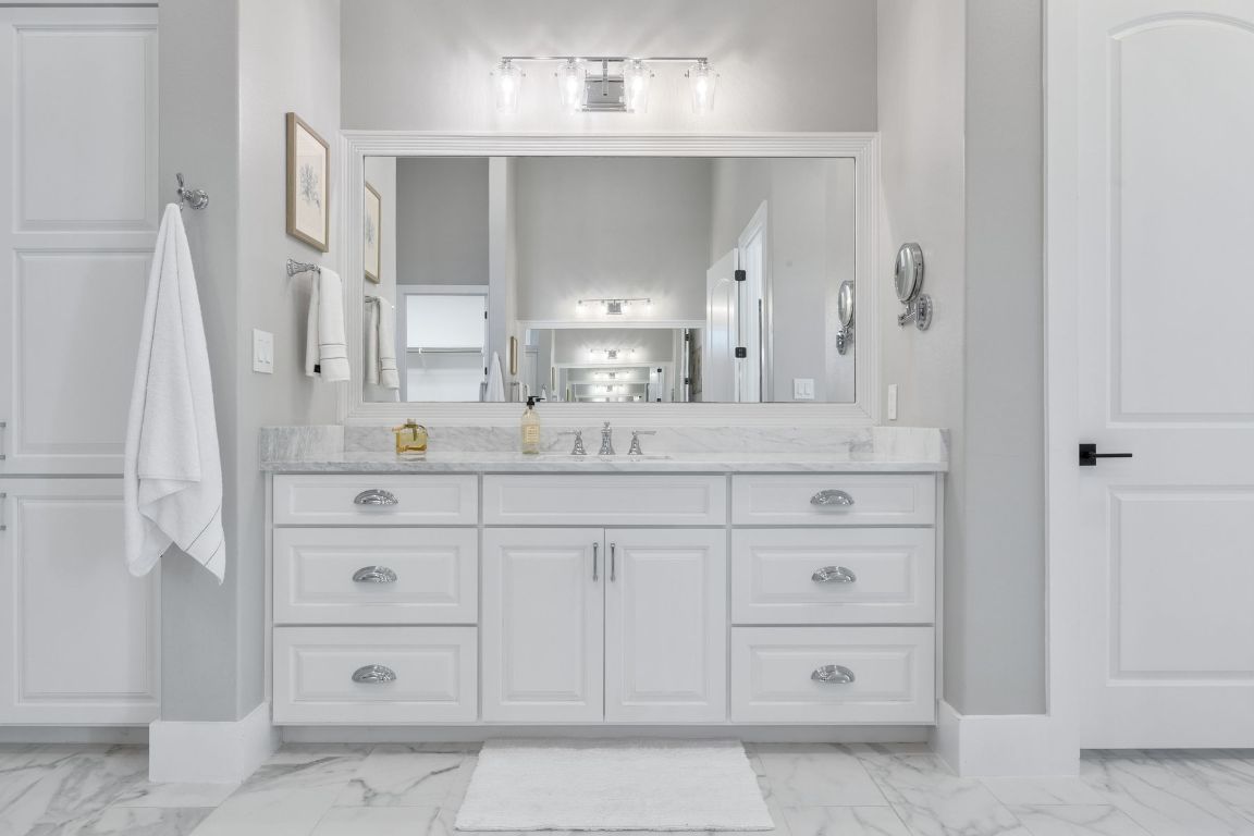496 Primo Fiore Terrace Austin, TX 78738 - Photo 14 of 40 a bathroom with a sink vanity and mirror