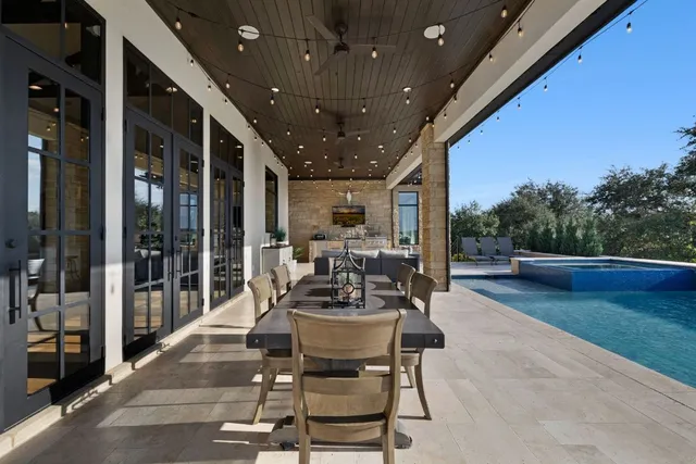 a view of a patio with table and chairs and potted plants