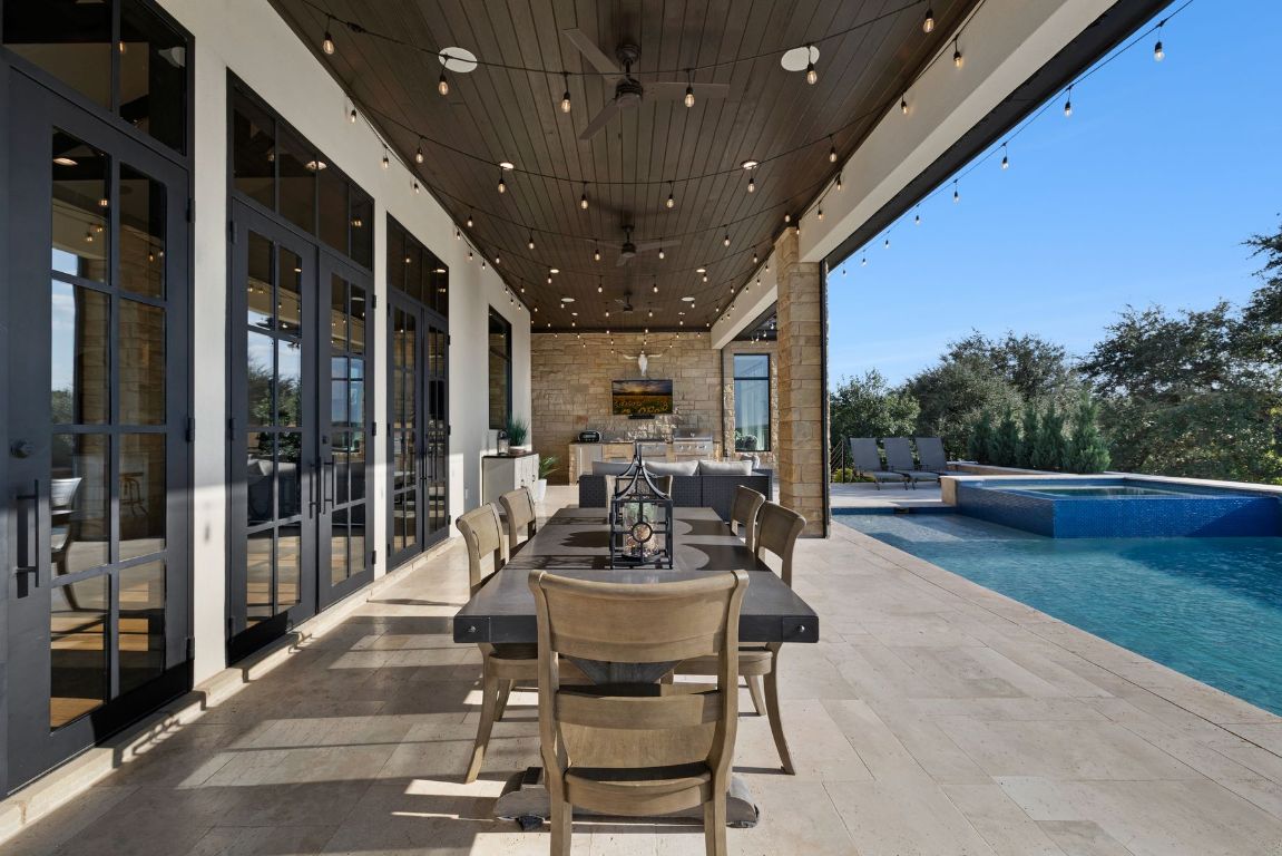 496 Primo Fiore Terrace Austin, TX 78738 - Photo 21 of 40 a view of a patio with table and chairs and potted plants
