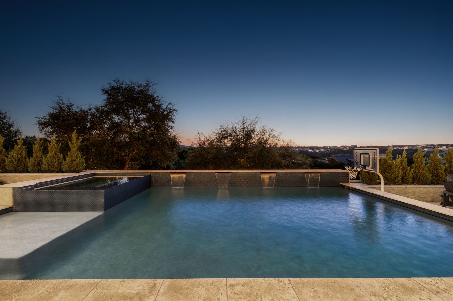 496 Primo Fiore Terrace Austin, TX 78738 - Photo 23 of 40 Pool at dusk featuring a pool with connected hot tub