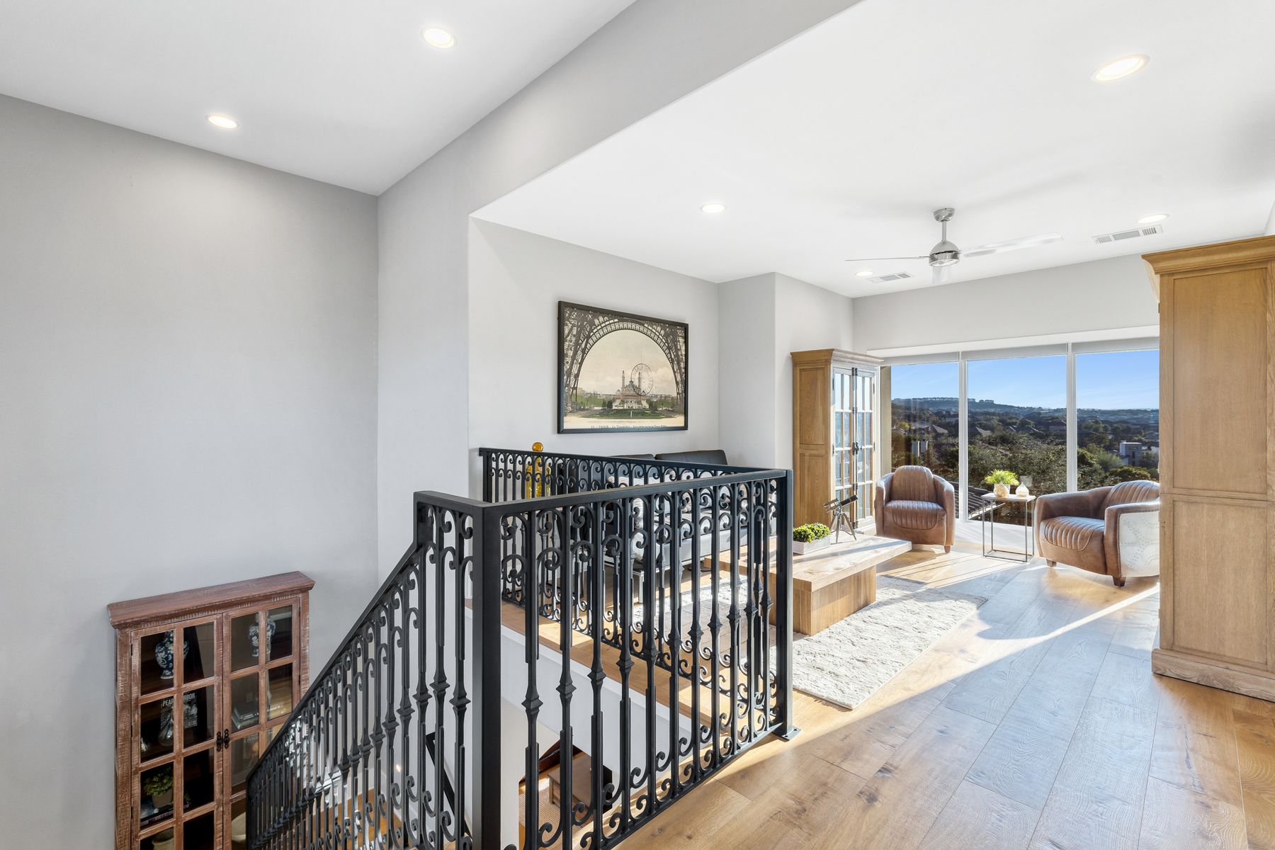 496 Primo Fiore Terrace Austin, TX 78738 - Photo 25 of 40 Corridor with an upstairs landing, wood-type flooring, and recessed lighting